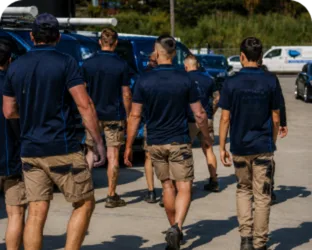 Plumbers walking to their service vans on a Drummoyne job