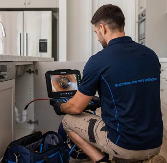 Clearing a blocked sink at a Drummoyne property